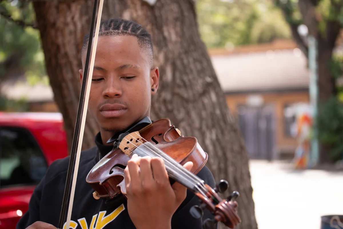 Young violinist performing outdoors